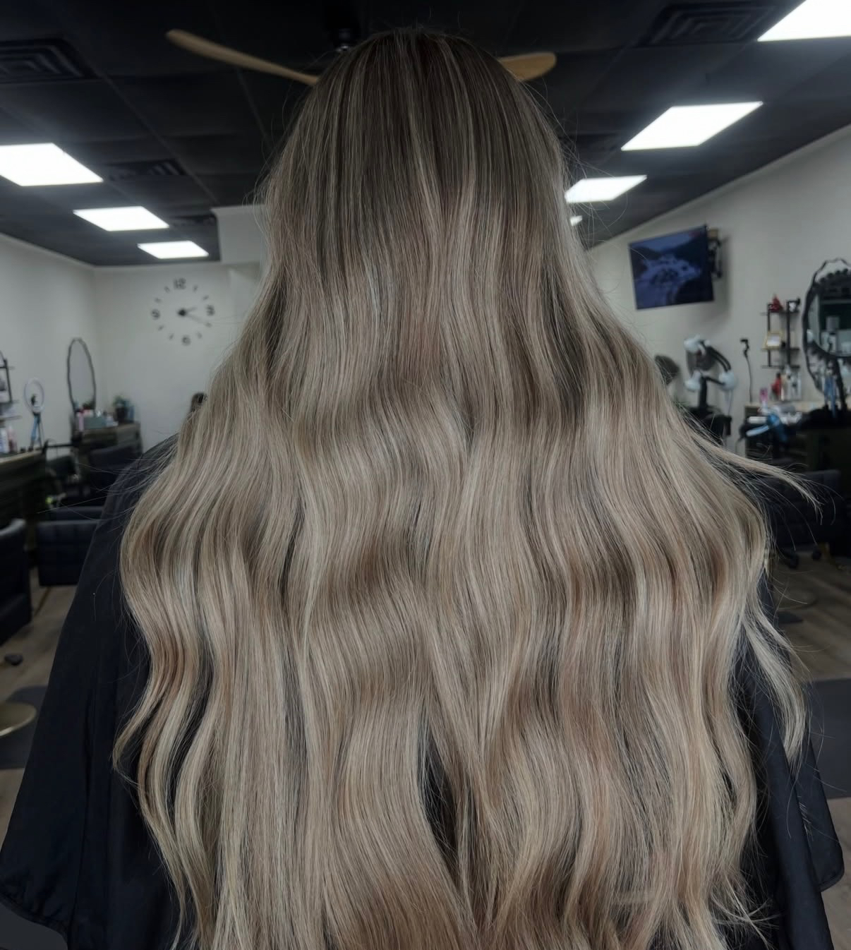Ash blonde balayage on long wavy hair styled at The Hair Collective salon Oklahoma City